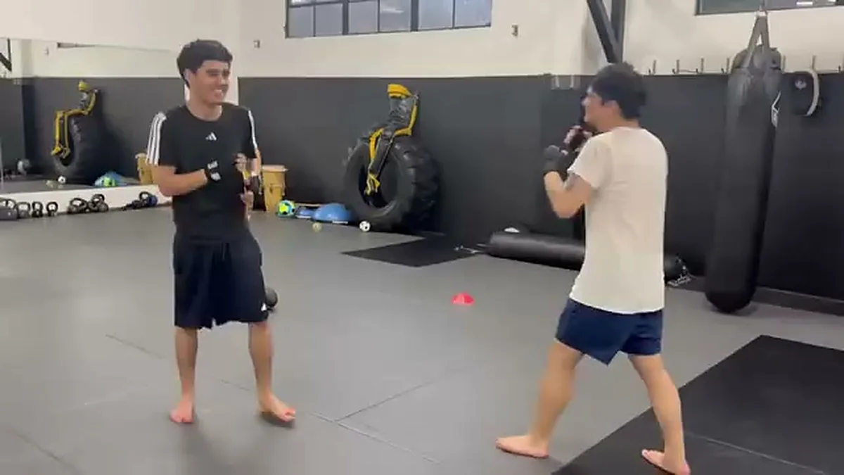 Two smiling students doing a light technical sparring drill at AB MMA