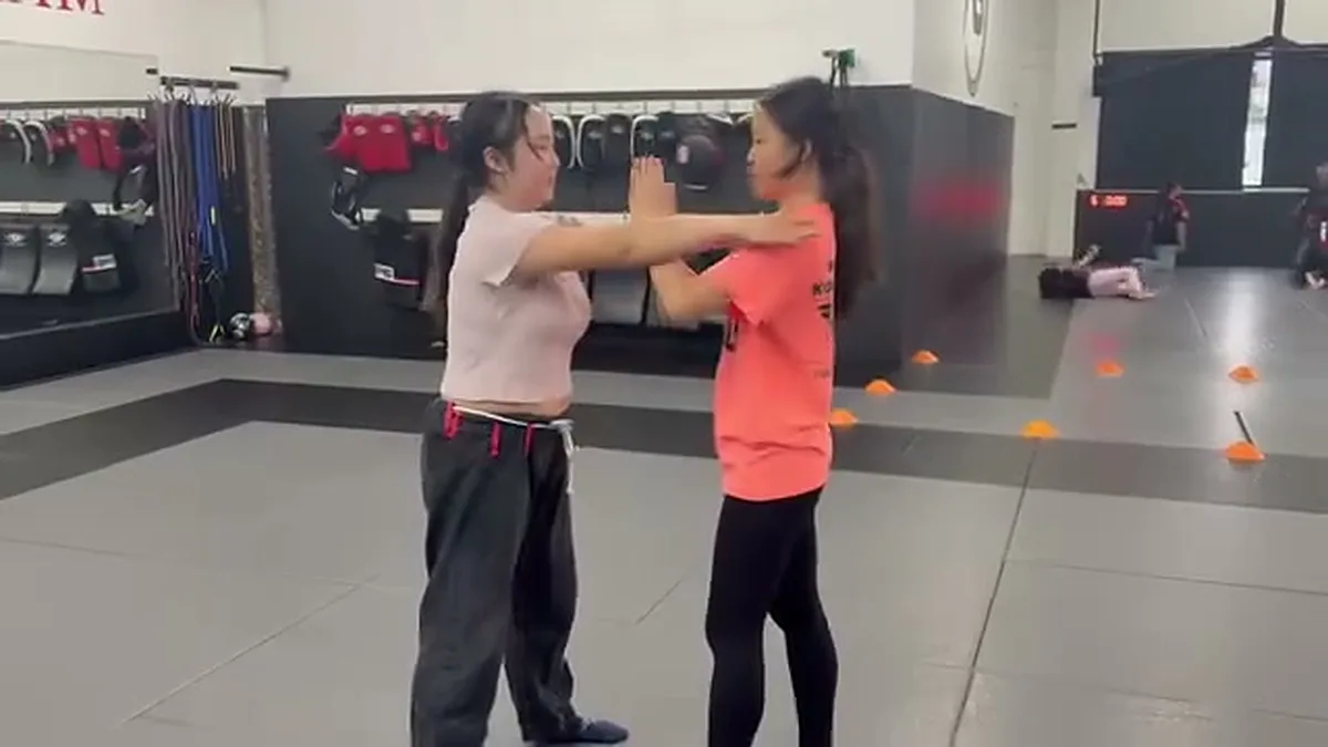 Women practicing how to break a shoulder grab during a self-defense class at AB MMA San Francisco