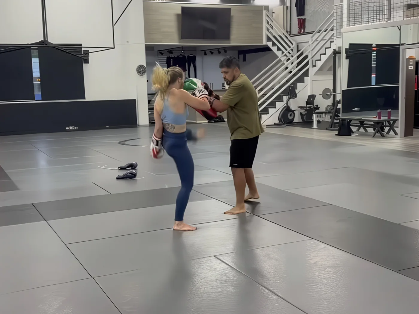 Beginner Muay Thai student with a coach at AB MMA