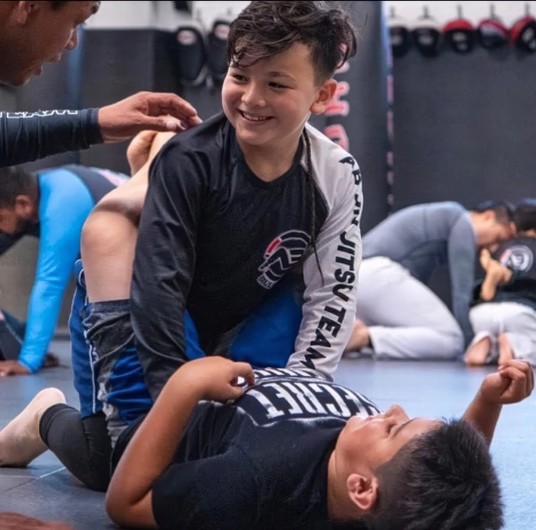 Boy smiling during BJJ sparring