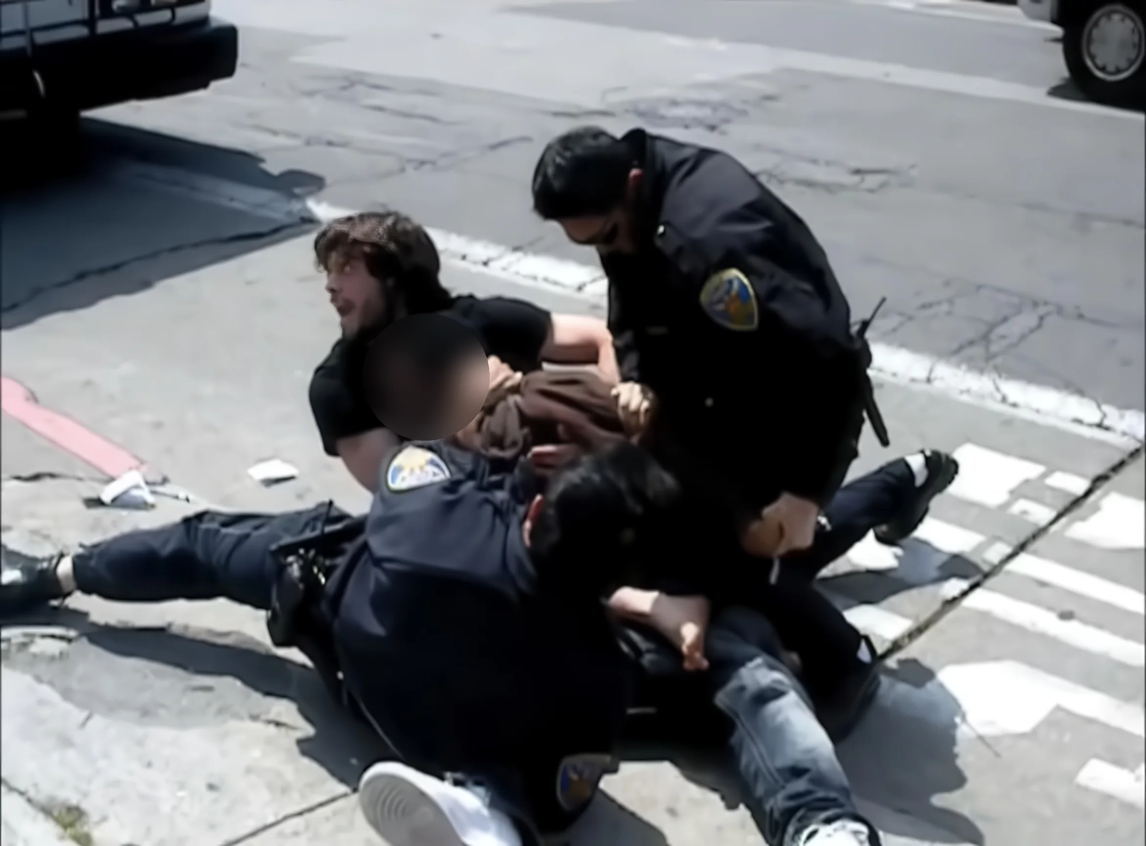 Video still: Pedro Arrigoni holding the attacker under control on the street while San Francisco police officers make the arrest, April 2011