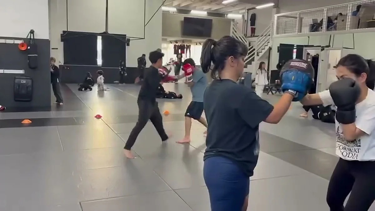 Two women practicing kickboxing pad work during a class at AB MMA on San Bruno Avenue in San Francisco